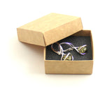 Pair of baltic amber earrings with silver in an open brown box on a white background